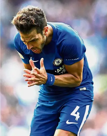  ?? — Reuters ?? Early shower: Chelsea’s Cesc Fabregas reacts after being sent off in the match against Burnley on Saturday.