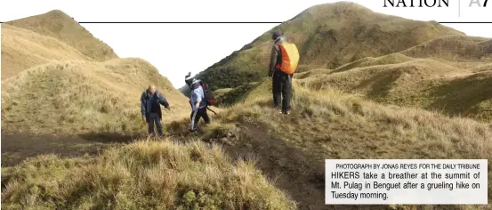  ?? ?? PHOTOGRAPH BY JONAS REYES FOR THE DAILY TRIBUNE HIKERS take a breather at the summit of Mt. Pulag in Benguet after a grueling hike on Tuesday morning.