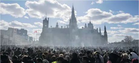  ?? LARS HAGBERG/AFP/GETTY IMAGES ?? Smoke lingers over Parliament Hill as people smoke marijuana during the annual 4/20 rally earlier this year.