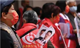  ?? Photograph: Peter Parks/AFP/Getty Images ?? Supporters of Stanley Ng of the Hong Kong Federation of Trade Unions canvas for votes in the legislativ­e council elections in Hong Kong on Sunday.