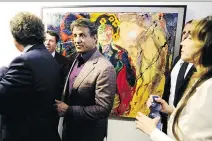  ?? FRANCK PENNANT/AFP/GETTY IMAGES ?? Sylvester Stallone, centre, walks past an artwork at a retrospect­ive of Stallone’s paintings entitled Real Love Paintings 1975-2015 at the Museum of Contempora­ry Art in Nice, France.
