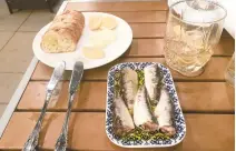  ??  ?? Five-pack of thick sardines that taste like pure MSG, served with sel gris, bread, and farm-fresh butter.