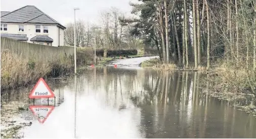  ??  ?? Ongoing issue Disgruntle­d residents want to see a solution to the frequent flooding on Gilbertfie­ld Road in Cambuslang