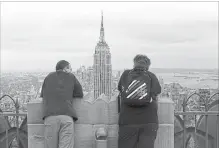  ?? SPENCER PLATT GETTY IMAGES ?? The three-level deck atop 30 Rockefelle­r Plaza, which was designed to evoke the upper decks of a 1930s ocean liner, offers sweeping views and attracts about 3 million visitors a year.