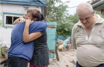  ?? DAVID GOLDMAN/AP ?? Nina Bilyk (left) is embraced by her friend, Olga Gurina, as she mourns the loss of her partner, Ivan Fartukh, on Saturday. He was killed in a Russian rocket attack on Kramatorsk, eastern Ukraine.