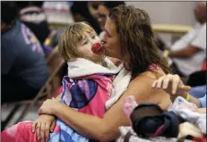  ?? RACHEL DENNY CLOW/CORPUS CHRISTI CALLER-TIMES ?? Heather Howard tries to get her daughter, Emma Howard, 2, to nap while waiting to evacuate from Corpus Christi, Texas, as Hurricane Harvey nears the coast on Friday.