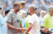  ?? AFP ?? Liverpool manager Juergen Klopp, left, and Manchester City boss Pep Guardiola shake hands before the Community Shield match.