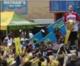  ?? THE ASSOCIATED PRESS ?? Reigning champion Joey Chestnut celebrates after winning the men’s competitio­n of the Nathan’s Famous Fourth of July hot dog eating contest, Wednesday in New York’s Coney Island.