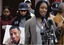  ?? STEVEN SENNE/AP FILE ?? Thulani DeMarsay, right, aunt of Danroy “DJ” Henry Jr., who was shot and killed by a police officer, speaks at a news conference in April 2011 as Henry’s uncle Jamele Dozier, left, holds a photograph of Henry.