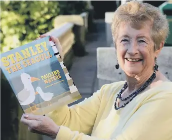  ??  ?? Author Pauline Walters with a copy of her first book.