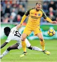  ??  ?? Beaten: Glenn Murray gets the ball before Nathan Dyer during a bad day for Swansea