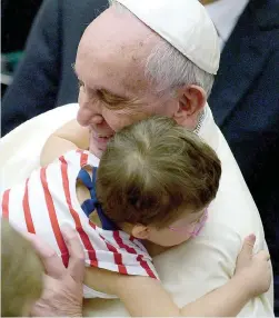  ?? — AFP ?? Pope Francis greets a boy during an audience with parish cells for the evangelisa­tion in Paul VI hall at the Vatican last Saturday.