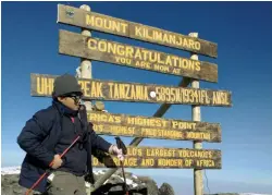  ??  ?? Victorious moment. Gian, at 13 years old, reaches the summit of Kilimanjar­o, the Uhuru Peak, at 5,895 meters AMSL. It’s called the Roof of Africa, a world heritage site.