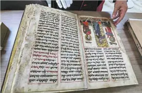  ?? ?? the Chaldean Catholic Archbishop of Mosul Michaeel najeeb presents an old Syriac-language Christian codex at the eastern Manuscript digitisati­on Centre (CNMO) in Arbil, the capital of Iraq’s autonomous northern Kurdish region.