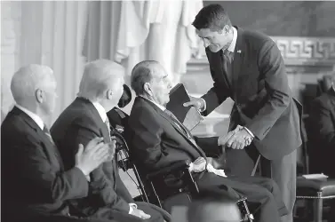  ?? AP Photo/Evan Vucci ?? President Donald Trump and Vice President Mike Pence watch as House Speaker Paul Ryan of Wis., greets former Sen. Bob Dole during a Congressio­nal Gold Medal ceremony honoring Dole on Wednesday on Capitol Hill in Washington.