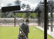  ?? Jason Fochtman / Staff photograph­er ?? A woman washes windows during a tour of the new Donald J. Stockton Junior High School in Conroe.