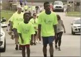  ?? KCTV VIA AP ?? Ralph Yarl, right, wearing a “Team Ralph” shirt, participat­es in a walk at Loose Park in Kansas City, Mo., on Monday.