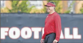  ?? CURTIS COMPTON / CCOMPTON@AJC.COM ?? UGA second-year coach Kirby Smart smiles as he takes the field to watch the first day of spring practice.