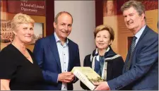  ?? All photos by Michelle Cooper Galvin. ?? Daniel O’Connell Summer School Director Professor Maurice Bric (right) presenting ‘Letters of a Dead Man’ to Dr Olivia O’Leary, with O’Connell Summer School Director Mary O’Connor and Micheál Martin at the Daniel O’Connell Summer School in the Library, Cahersivee­n, on Friday.