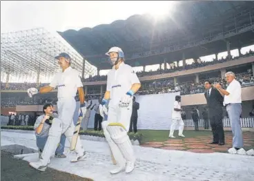  ?? GETTY ?? South Africa openers Jimmy Cook (L) and Andrew Hudson walk out to bat at the Eden Gardens on November 12, 1991 for their first internatio­nal match after a 21-year ban from cricket. Ali Bacher (2nd R) was an UCBSA administra­tor and manager of the team.