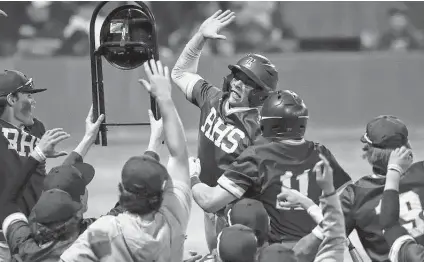  ?? Kin Man Hui / Staff photograph­er ?? Reagan's Cole Tabor, center, leaps to celebrate after scoring one of eight runs against Johnson in the fifth inning on Friday night.