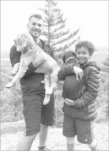  ?? COURTESY SHANNA YOUNG ?? Felix and Ryan on a hike with furry friends George and Allison