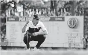  ?? [AP PHOTO] ?? Gary Woodland looks at a putt on the 18th green during the first round of the PGA Championsh­ip golf tournament at Bellerive Country Club in St. Louis on Thursday. Woodland is the leader after the opening round.