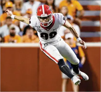  ?? BOB ANDRES / ROBERT.ANDRES@AJC.COM ?? Georgia placekicke­r Rodrigo Blankenshi­p, going airborne after he kicks off during UGA’s game against Tennessee at Neyland Stadium, is wildly popular with Bulldogs fans.