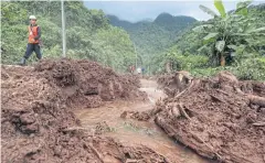  ?? WICHAN CHAROENKIA­TPAKUL ?? Muddy water flows down a slope as rescuers continue to drain floodwater from Tham Luang cave.