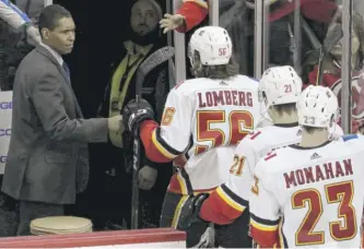  ?? JULIO CORTEZ/AP ?? Calgary Flames assistant coach Paul Jerrard greets Flames players as the team leaves the ice after defeating the New Jersey Devils in a 2018 game in Newark, N.J.
