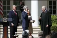  ?? CAROLYN KASTER — THE ASSOCIATED PRESS ?? President Donald Trump watches as Supreme Court Justice Anthony Kennedy administer­s the judicial oath to Justice Neil Gorsuch during a re-enactment in the Rose Garden of the White House White House in Washington, Monday. Holding the bible is Gorsuch’s...