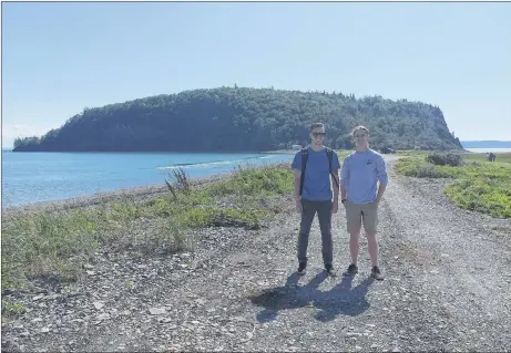  ??  ?? Patrick Henger (left) and Hunter Smith (right) in front of Partridge Island. At the ocean’s edge you can see the boiling tide.