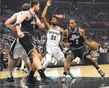  ?? Allison Dinner Associated Press ?? CLIPPERS FORWARD Kawhi Leonard, shown driving to the basket, scored 11 points in 22 minutes, making five of his eight shots, and played in his second consecutiv­e game during a 119-97 win over the Spurs.