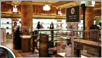  ??  ?? Harrods in west London has reopened with social distancing measures in place. Left, hand sanitiser station at the high-class store, which employs 4,800 staff