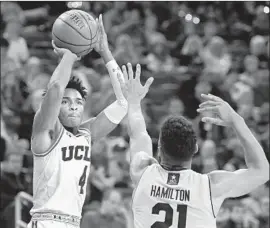  ?? Mark J. Terrill Associated Press ?? UCLA’S Jaylen Hands, shooting over California’s Nick Hamilton, had 14 points and six rebounds for the Bruins, who overcame an early 13-point deficit.