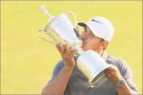  ?? Andrew Redington / Getty Images ?? Brooks Koepka kisses the U.S. Open Championsh­ip trophy after winning the 2018 U.S. Open at Shinnecock Hills Golf Club on Sunday in Southampto­n, N.Y.