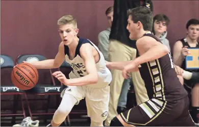  ?? Jeremy Stewart ?? Unity Christian’s Austin Wilkerson (left) drives toward the goal around a Praise Academy player during Tuesday night’s GAPPS Region 1-A game at The Lion’s Den at Unity Christian School.