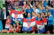  ?? — AP ?? Croatian players and coach Zlatko Dalic celebrate after the semifinal win over England.