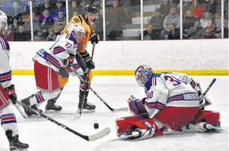  ??  ?? Summerside's Brodie MacMillan and Yarmouth's Ben Charles jockey for the puck near the boards on this play during a Jan. 11 division rival between the Western Capitals and the Mariners. Summerside won the game 5-3, with the last goal being scored on the empty net, during the game which was a tight match-up from start to finish.