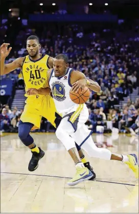  ?? EZRA SHAW/GETTY IMAGES ?? The Warriors’ Andre Iguodala drives on the Pacers’ Glenn Robinson III at ORACLE Arena on March 27 in Oakland, Calif.