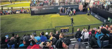  ??  ?? From left: Spectators enjoy Darren Clarke teeing off on the 1st to begin The Open Championsh­ip, and (below) former football referee Alan Snoddy and former footballer Bobby Carlisle