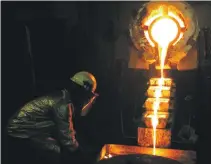  ?? Reuters ?? A worker pours gold at a mine in Ghana. The bullion price is not expected to climb in the near term