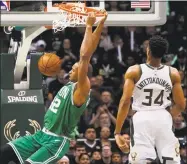  ?? Morry Gash / Associated Press ?? Boston’s Al Horford, left, dunks past Giannis Antetokoun­mpo during the first half on Thursday.
