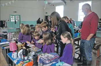  ?? 01_B25eco01 ?? Kilmory Primary School pupils inspect some of the items available at the Eco Savvy stall.