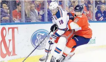  ?? MIKE EHRMANN/GETTY IMAGES ?? Marc Staal (18) of the New York Rangers and Aleksander Barkov (16) of the Florida Panthers fight for the puck during Tuesday’s game.