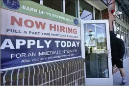  ?? ELISE AMENDOLA — THE ASSOCIATED PRESS ?? A man walks into a restaurant displaying a “Now Hiring” sign in Salem, N.H., on Thursday.