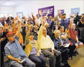  ??  ?? Supporters show at a campaign event Friday in Henderson that they have voted.