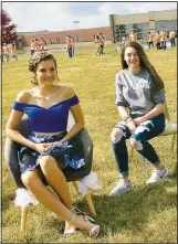  ??  ?? Homecoming queen candidate Aubrey Gebhart (left) poses with her friend Keeli Moore. Each of the three queen candidates were on hand to greet passersby in the unique reverse parade.