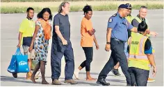  ?? ?? Prof Bryce Barker is escorted from a plane in Port Moresby following his release