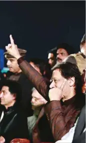  ?? ?? Former prime minister Imran Khan waves to the crowd in Rawalpindi yesterday whilst sitting on the stage as he recuperate­s from bullet injuries sustained in an assassinat­ion attempt on his life in Wazirabad early this month.